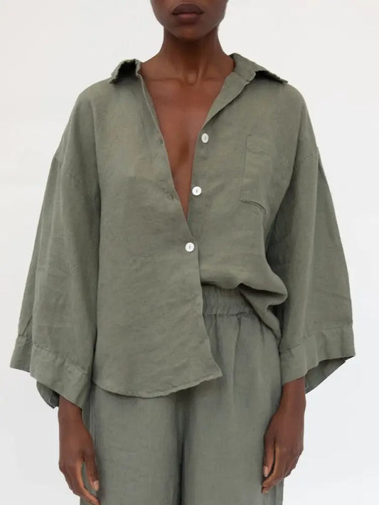 Person wearing a green outfit with a plain background