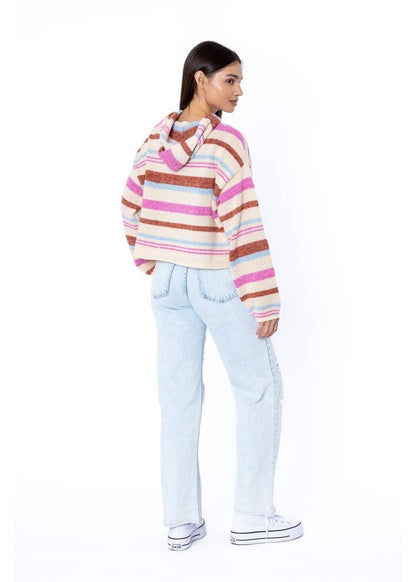 back of Woman wearing a striped sweater and light blue jeans on a white background