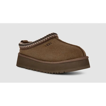 Brown UGG slipper on a white background